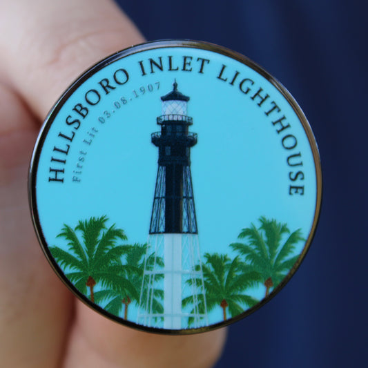 Round badge with Hillsboro Inlet Lighthouse design on a blue background