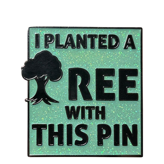 I Planted a Tree With This Pin eco enamel pin on green glitter background