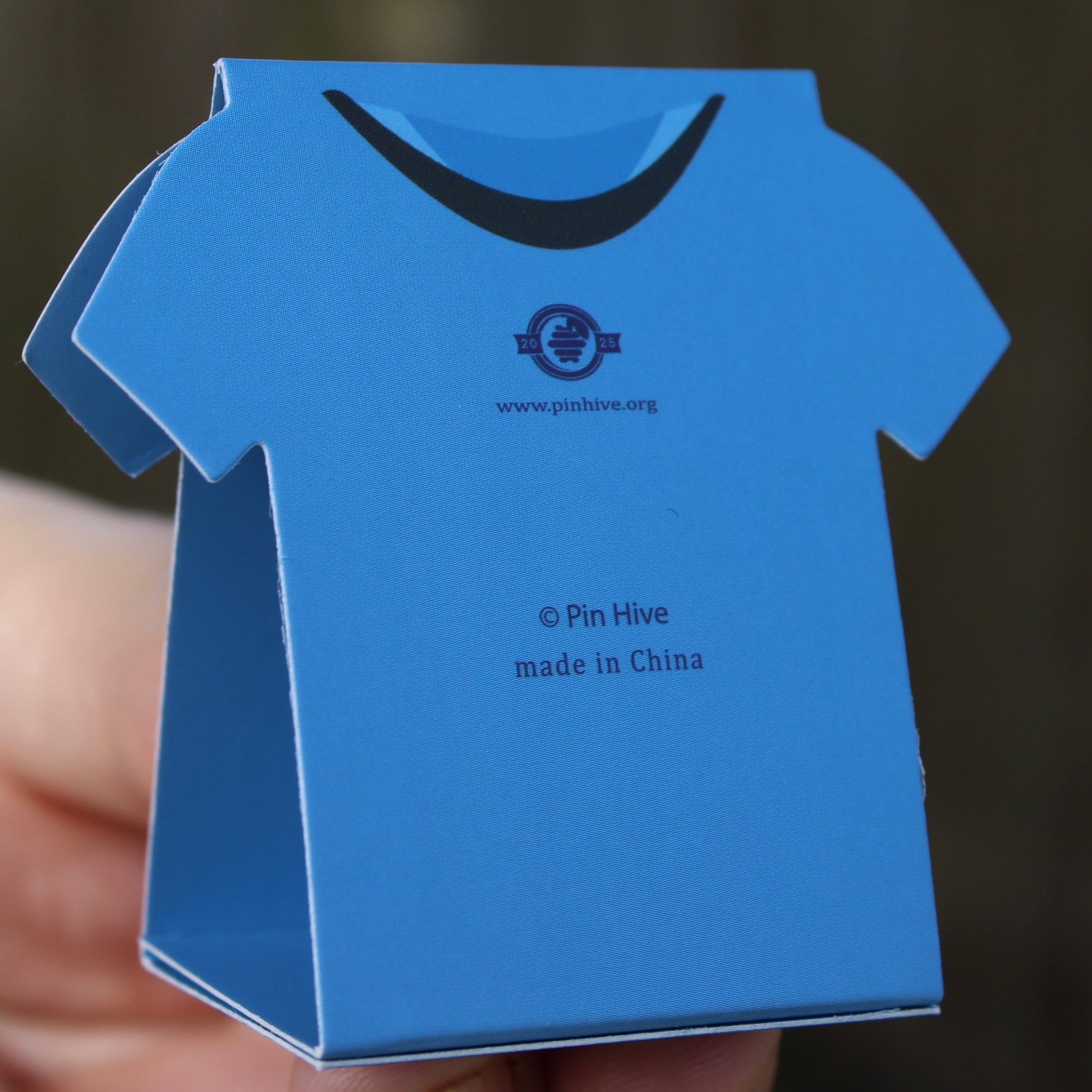 Side view of assembled scrub shaped display card being held upright 