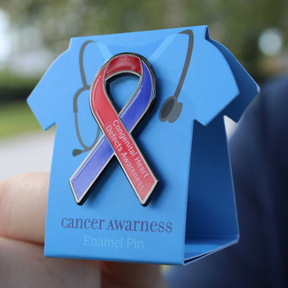heart defect awareness enamel pin on a blue card with a blurred background