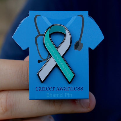 Cervical cancer awareness teal and white ribbon pin on blue scrub display stand