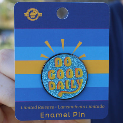 Enamel pin with 'Do Good Daily' text on a blue card