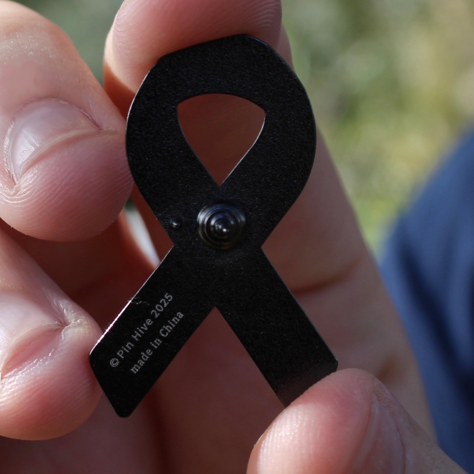 Black awareness ribbon enamel pin backstamp 