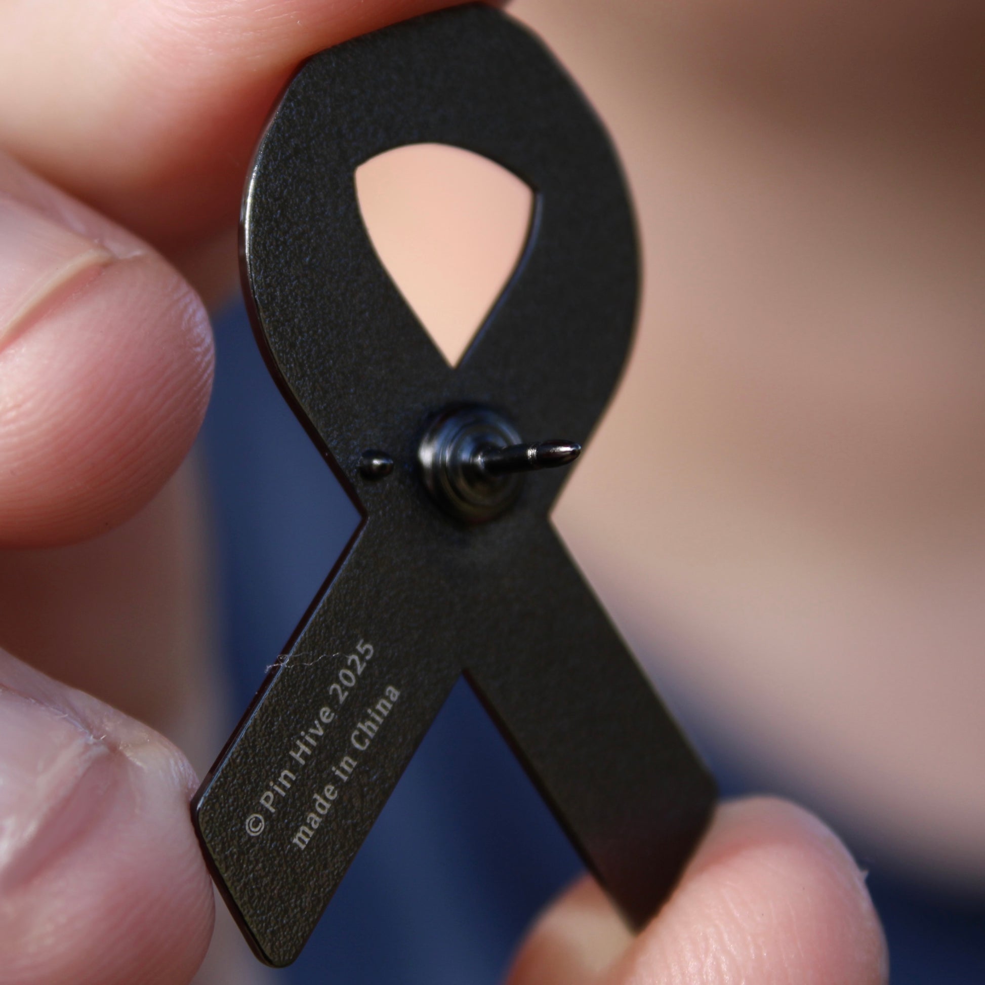 cancer awareness enamel pin back stamp and logo with font "pin hive 2025, made in china"