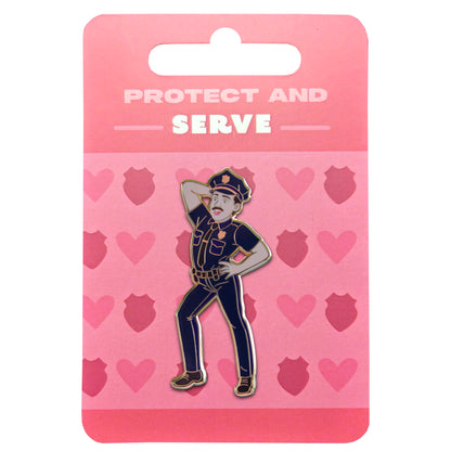 Pin with a police officer design on a pink card with 'Protect and Serve' text and heart patterns.